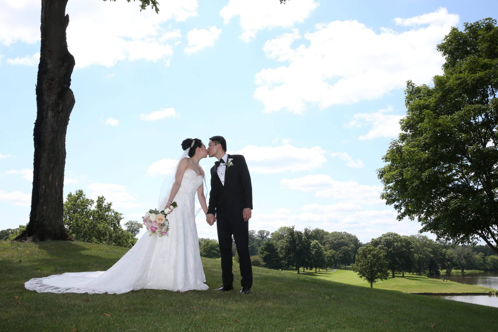 Brooklake bride and groom kiss on the lawn