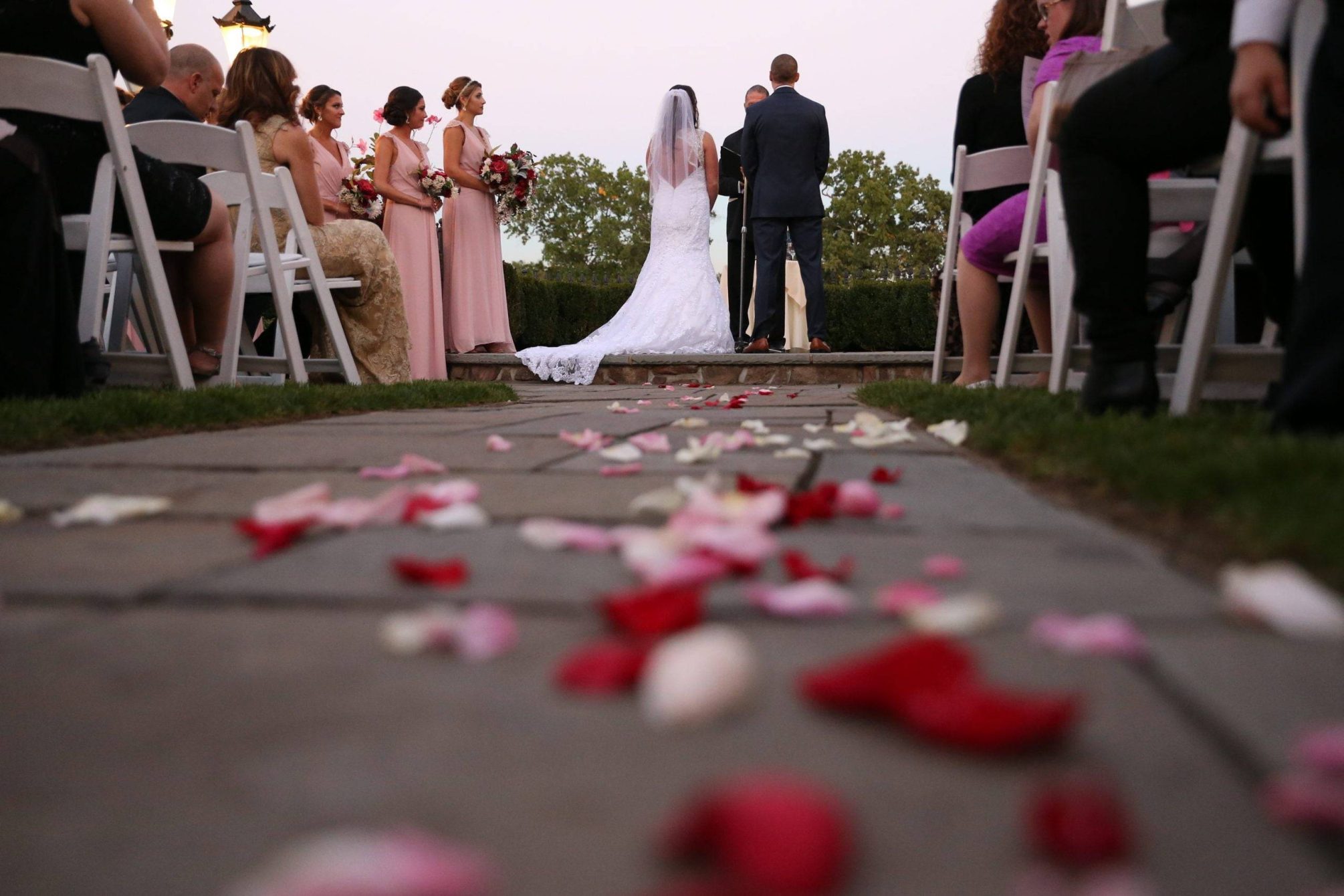 Park Savoy bride and groom with flower petals on the aisle