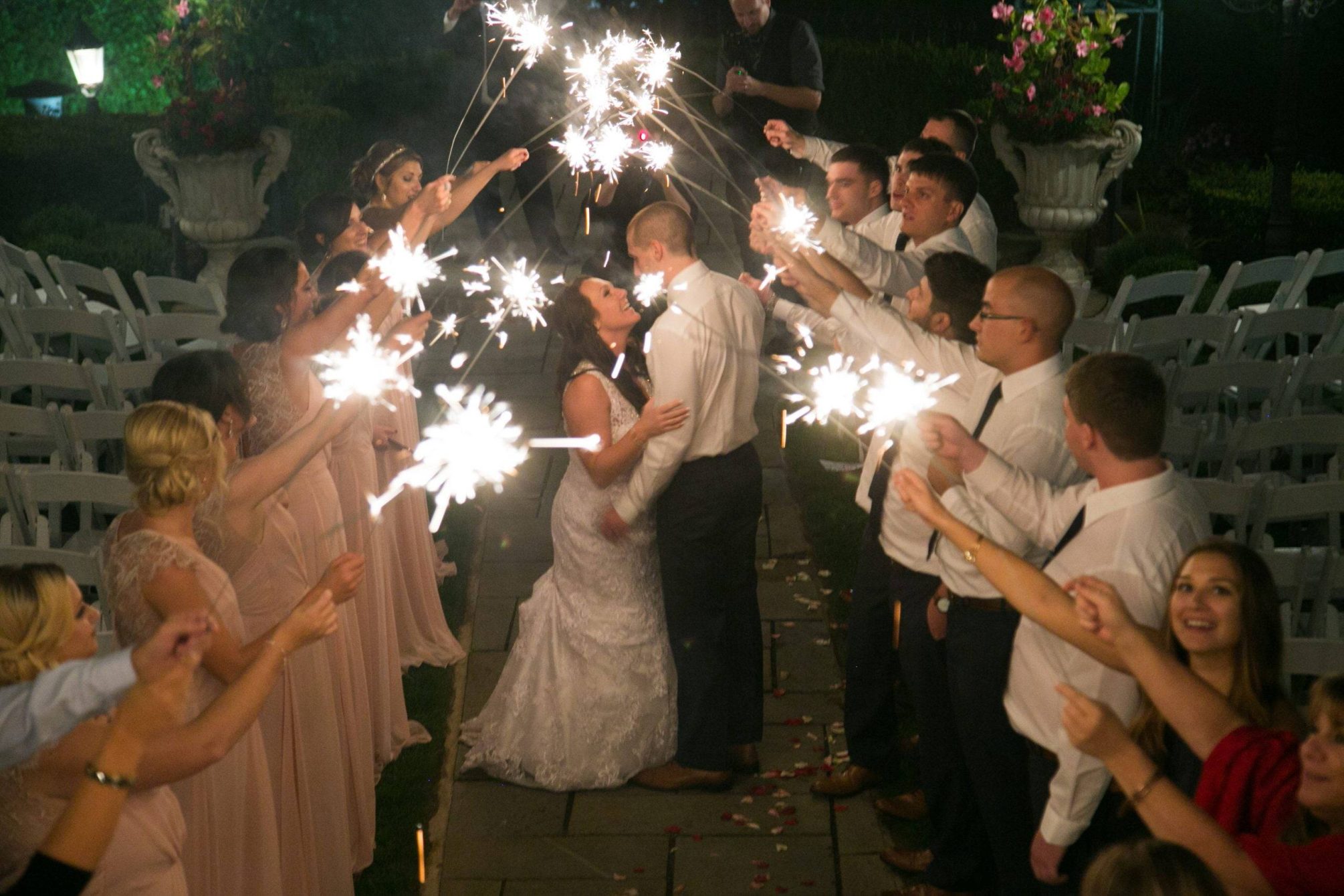 Park Savoy bride and groom kiss under sparklers