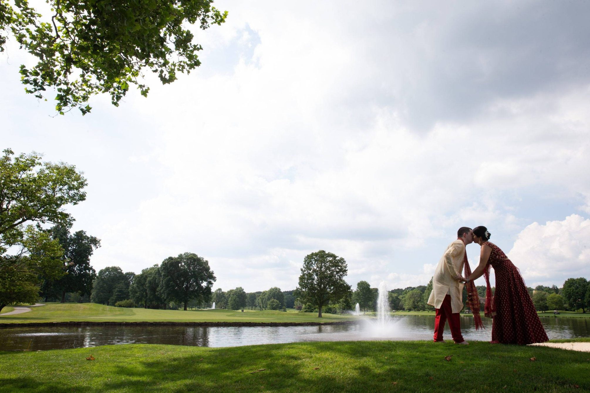 Brooklake Indian bride and groom kiss by the lake