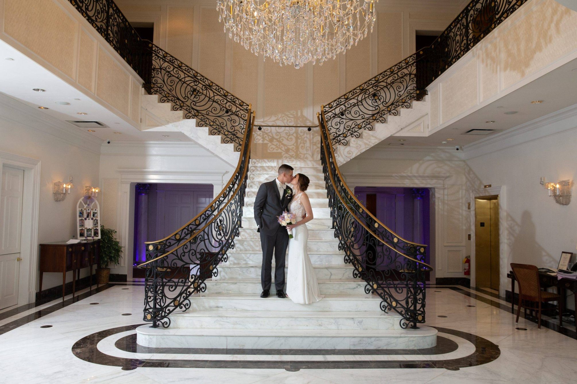 Meadow Wood wedding couple sneak a kiss on staircase