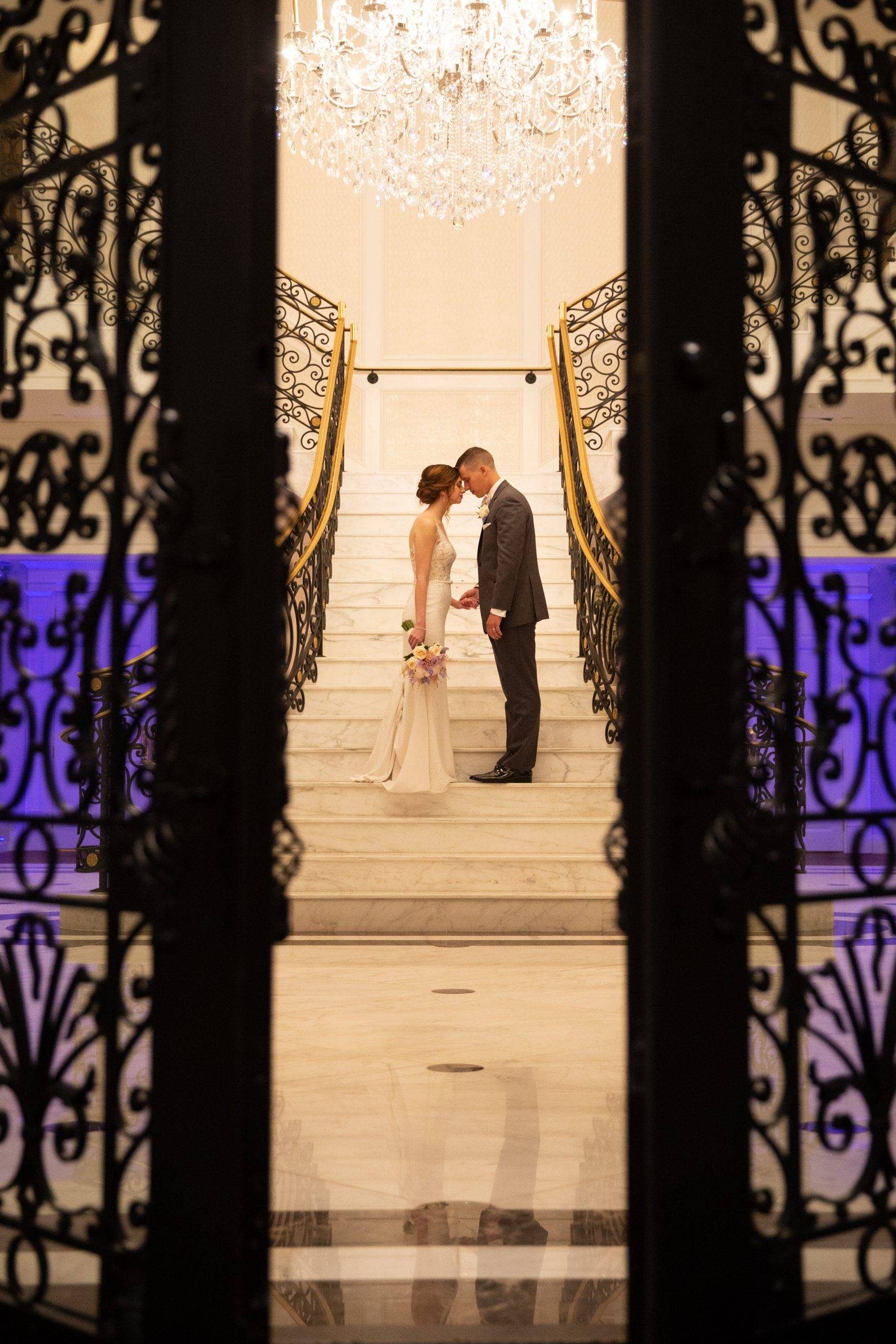 Meadow Wood wedding couple sneaking a kiss on the staircase