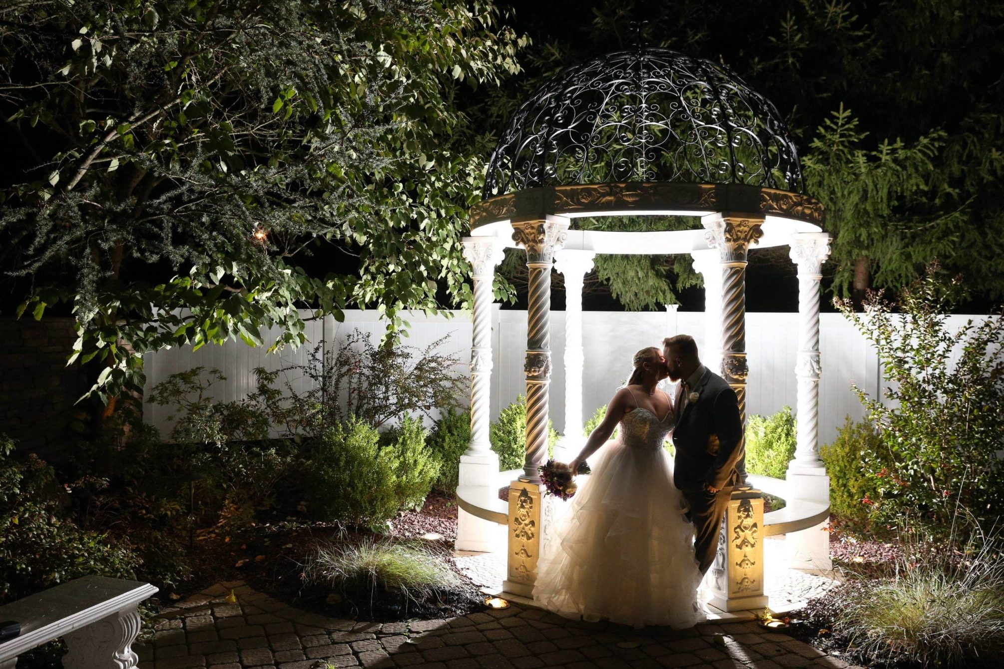 Primavera Regency bride and groom by lighted gazebo at night