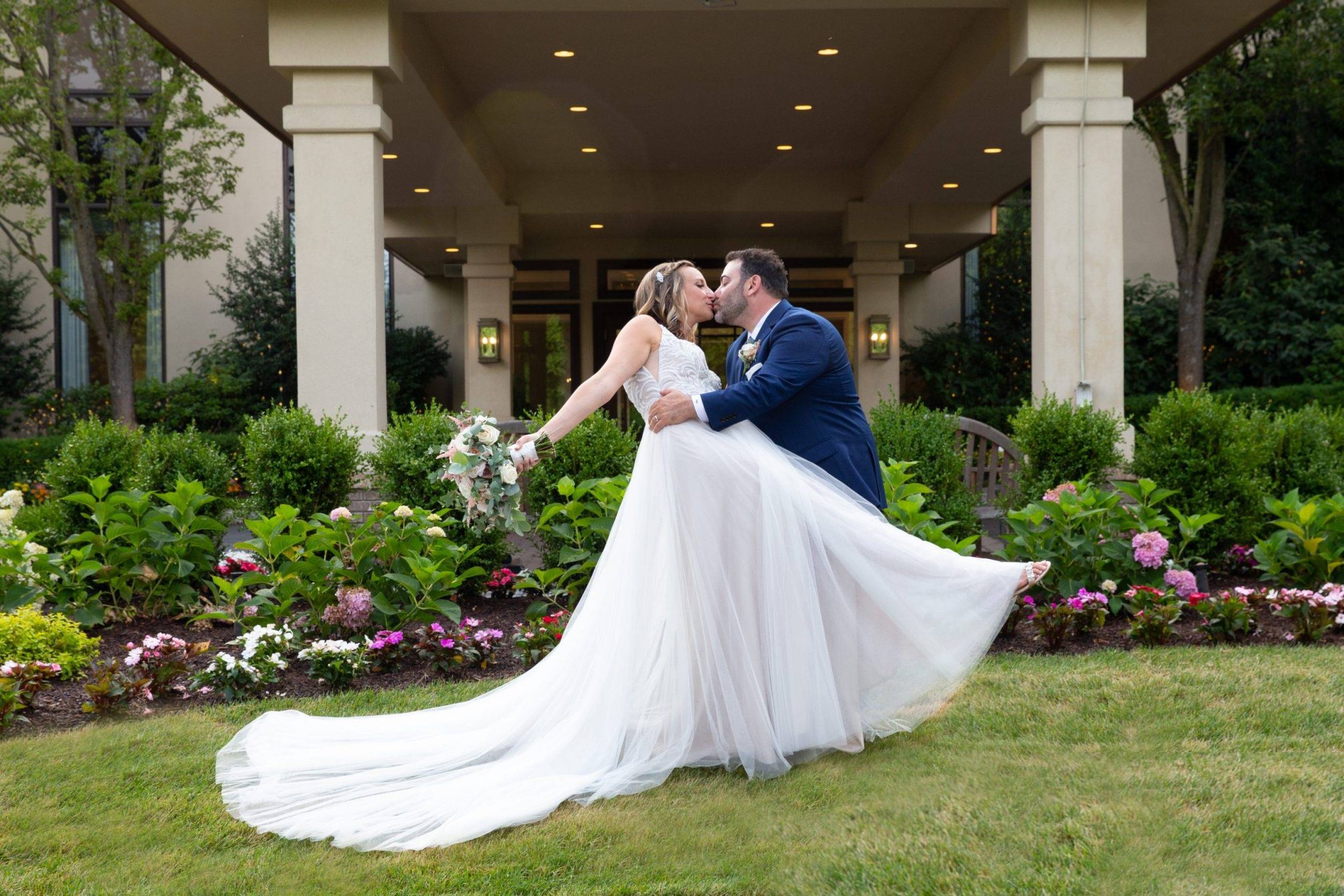 Brooklake bride and groom kissing by country club