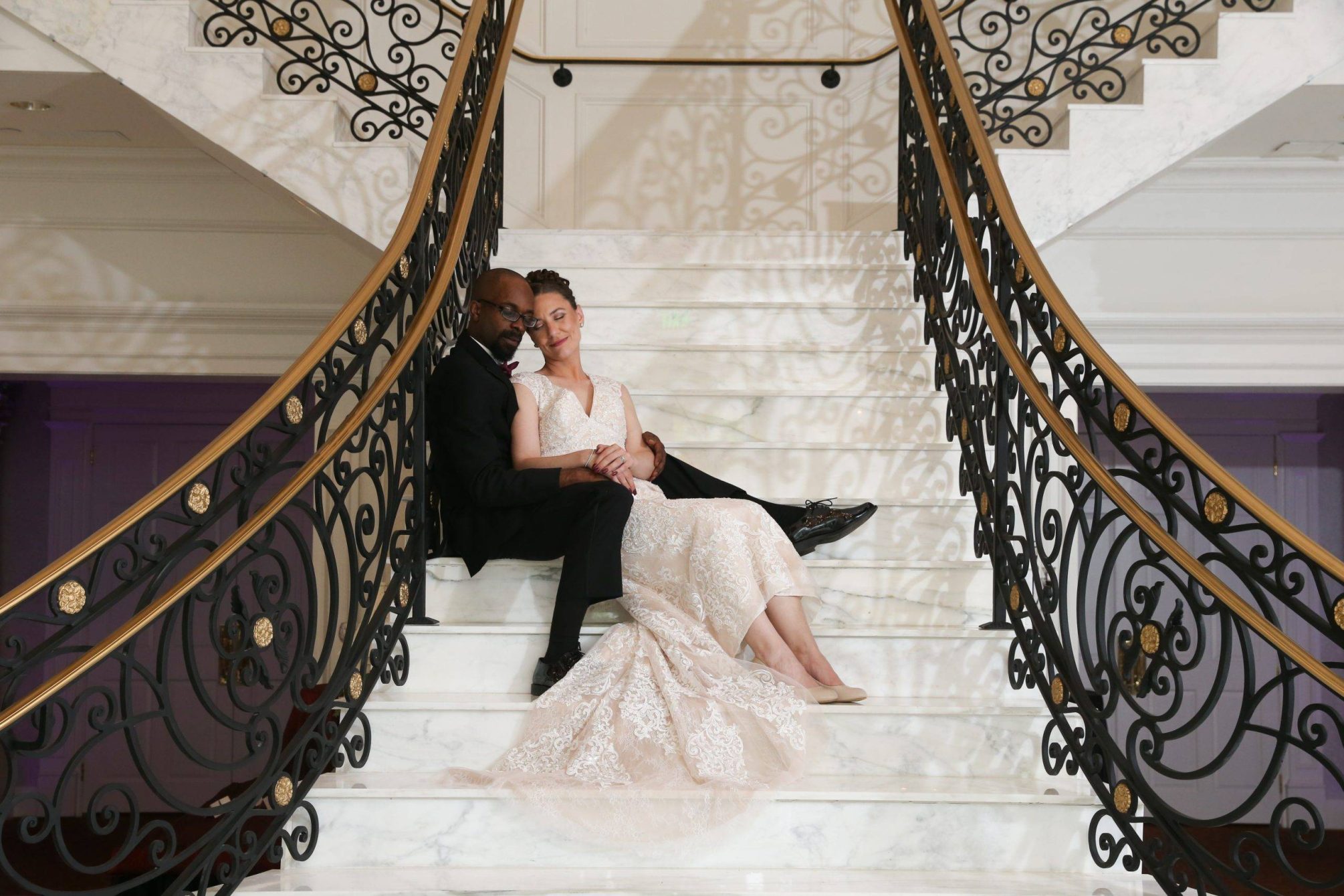 Meadow Wood bride and groom relaxing on grand staircase