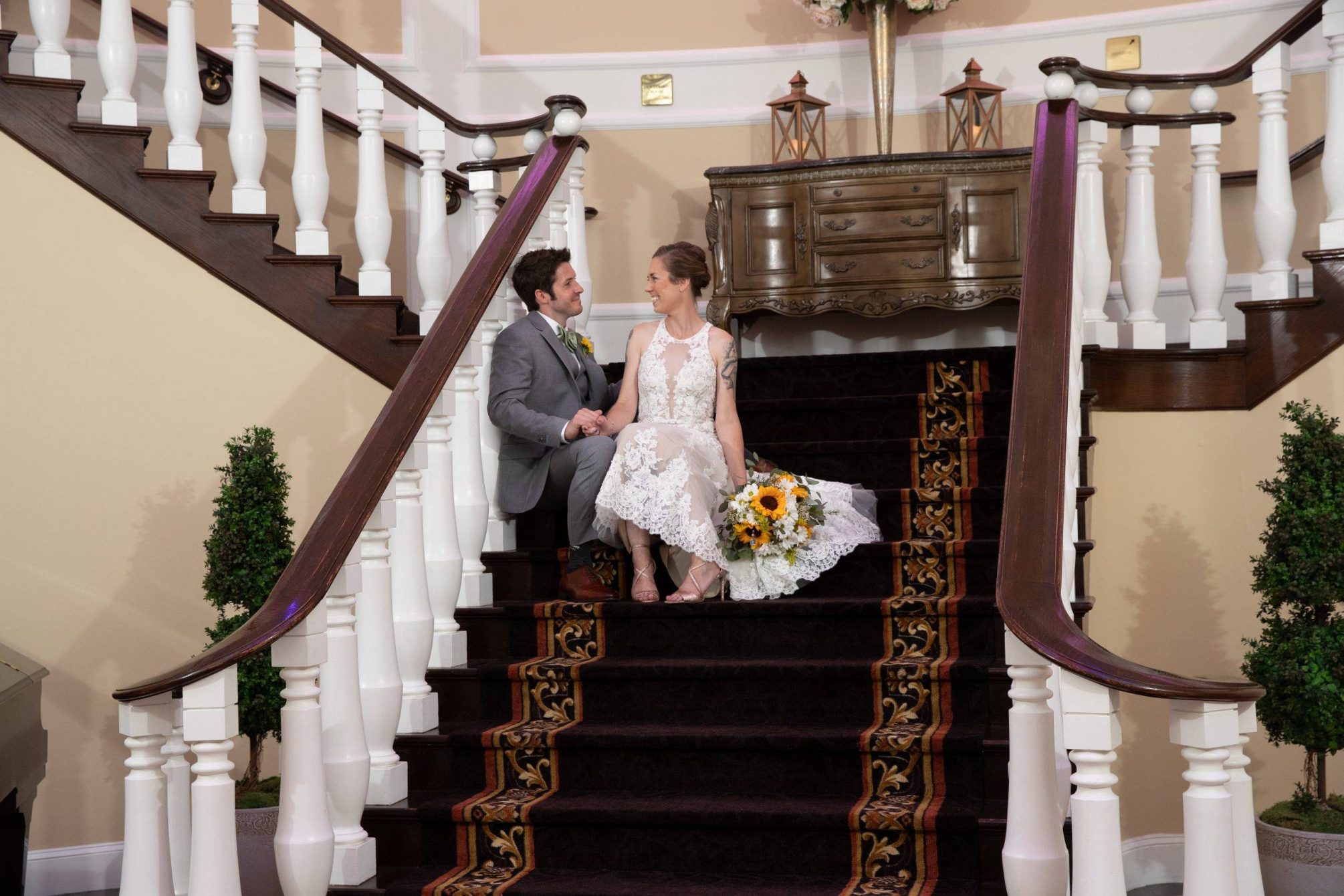 Bridgewater Manor bride and groom relax on staircase