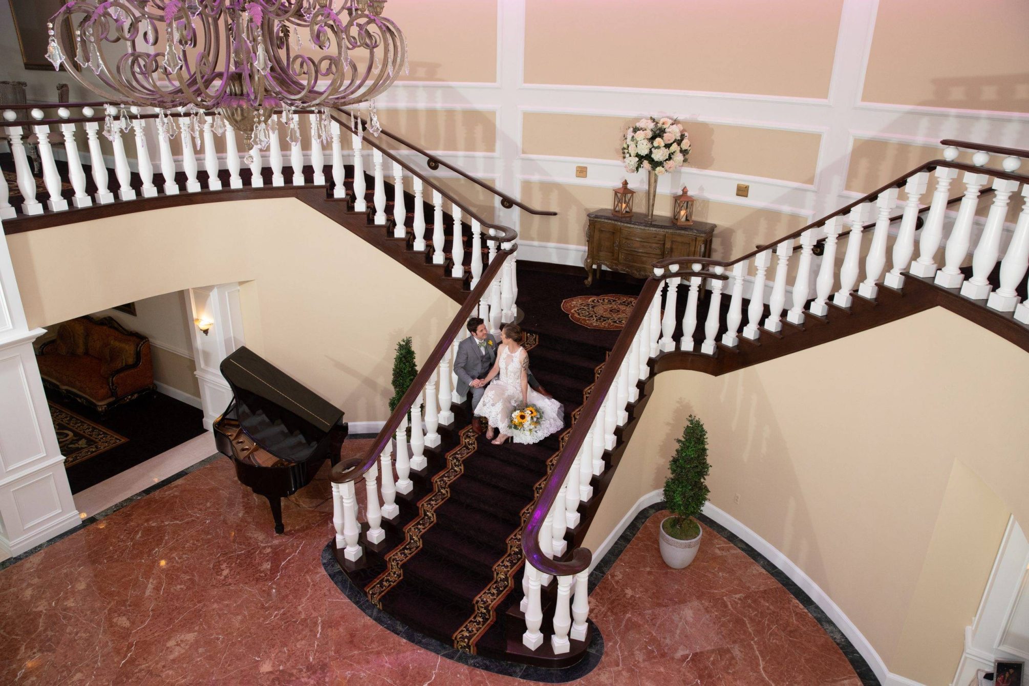 Bridgewater Manor wedding couple relaxing on staircase from above